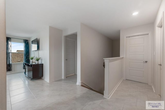 hall with light tile patterned floors