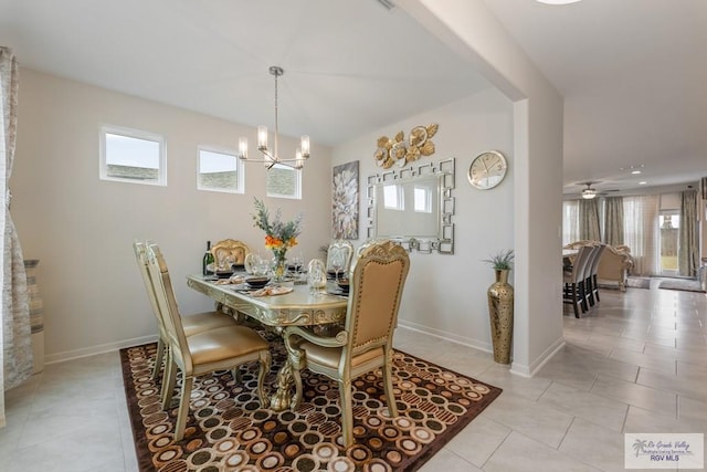 dining area featuring an inviting chandelier, light tile patterned floors, and plenty of natural light