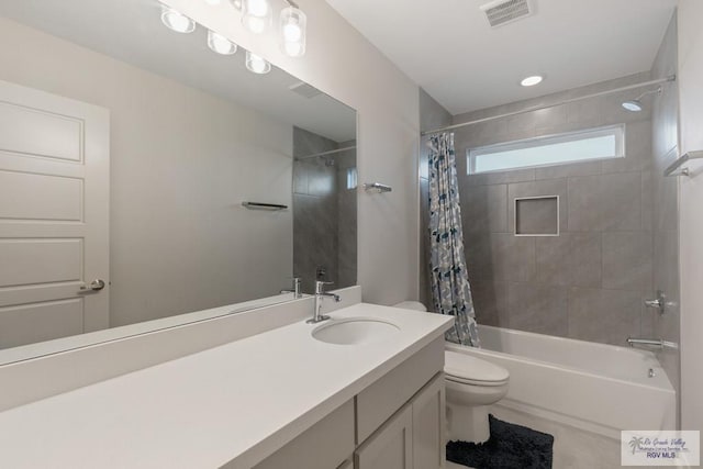 full bathroom featuring shower / bath combination with curtain, vanity, and toilet