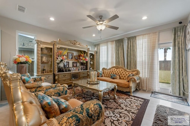 living room featuring light tile patterned flooring, a wealth of natural light, and ceiling fan