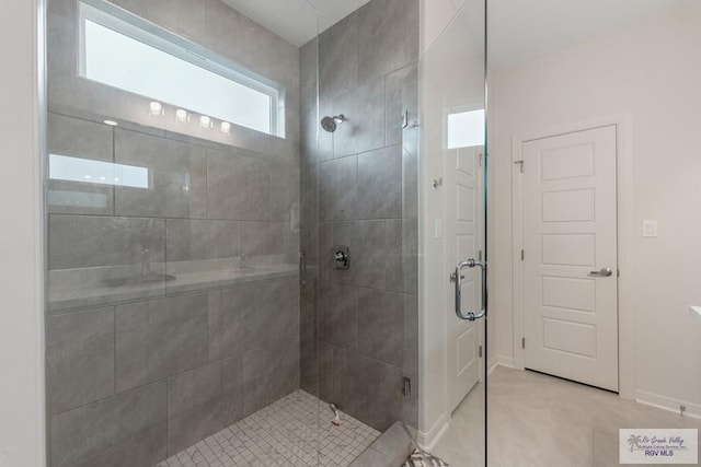 bathroom with tile patterned flooring and walk in shower