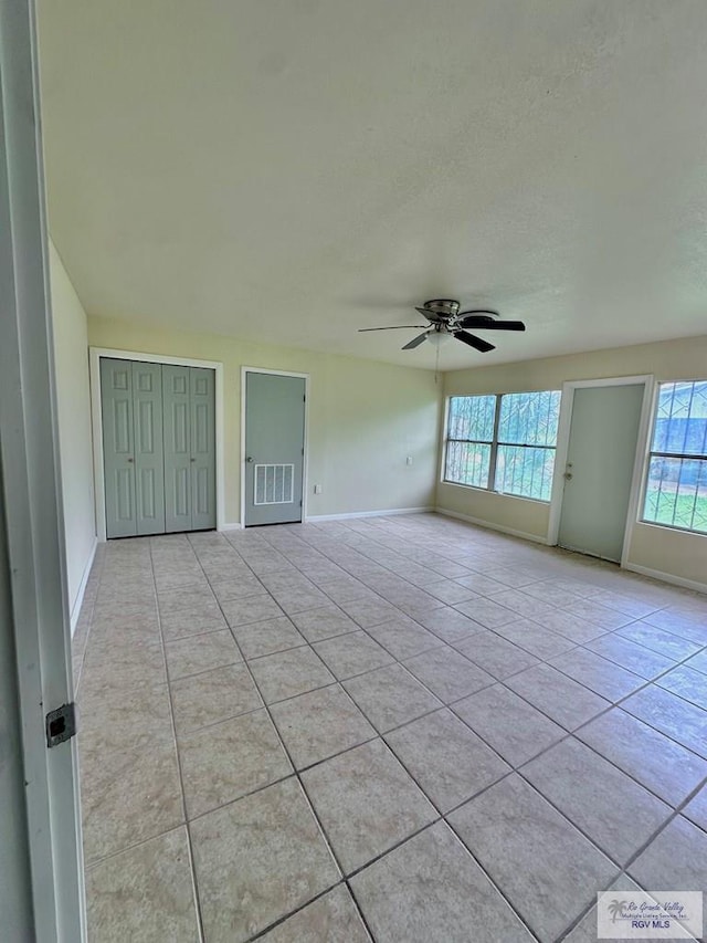 12776 State Highway 186, Raymondville, TX 78580 - spare room with baseboards, light tile patterned flooring, and ceiling fan