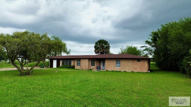 12776 State Highway 186, Raymondville, TX 78580 - ranch-style home featuring a front yard, an attached garage, and brick siding