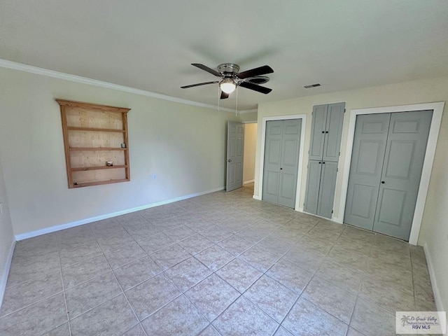 12776 State Highway 186, Raymondville, TX 78580 - unfurnished bedroom featuring two closets, light tile patterned floors, ornamental molding, a ceiling fan, and baseboards
