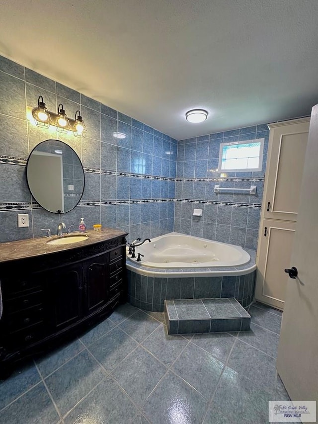 12776 State Highway 186, Raymondville, TX 78580 - full bath with tile patterned flooring, a tub with jets, vanity, and tile walls