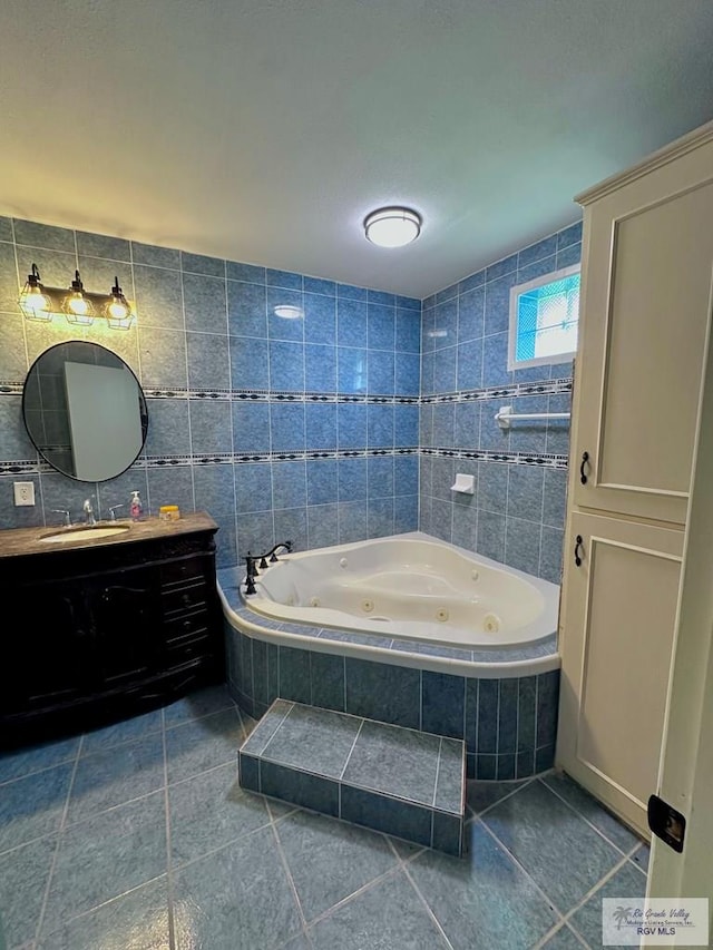 12776 State Highway 186, Raymondville, TX 78580 - bathroom with tile patterned flooring, a whirlpool tub, vanity, and tile walls