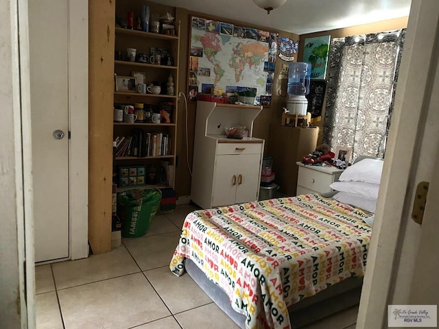 bedroom with light tile patterned floors