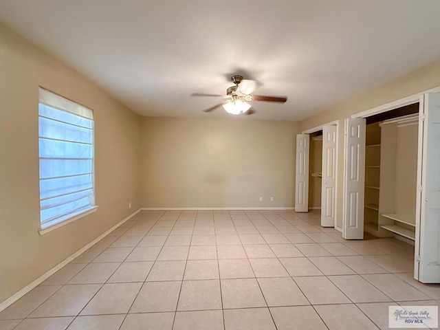 unfurnished bedroom featuring ceiling fan and light tile patterned floors