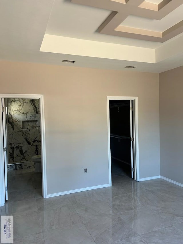 unfurnished room featuring a tray ceiling