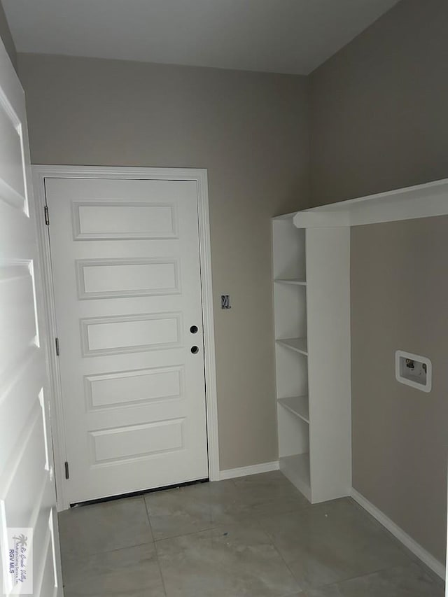 laundry room with washer hookup and light tile patterned floors