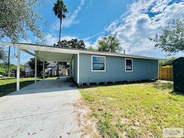 exterior space featuring a front yard and a carport