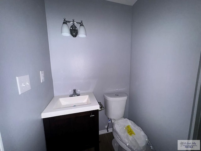 bathroom featuring vanity and toilet