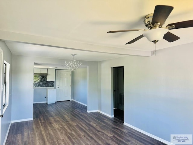 interior space with ceiling fan with notable chandelier and dark hardwood / wood-style flooring