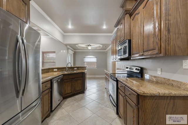 kitchen with stainless steel appliances, crown molding, light stone countertops, and sink