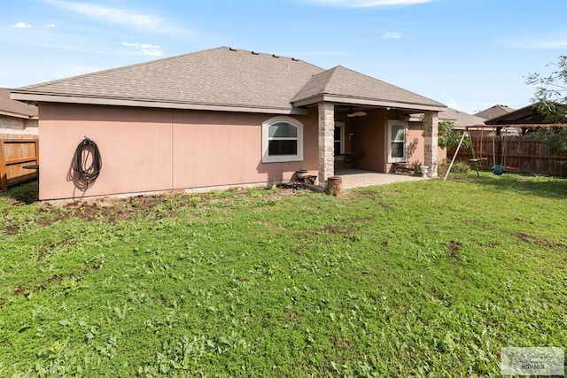 back of property featuring a yard and a patio area