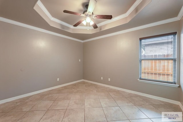 tiled empty room featuring crown molding, a raised ceiling, and ceiling fan