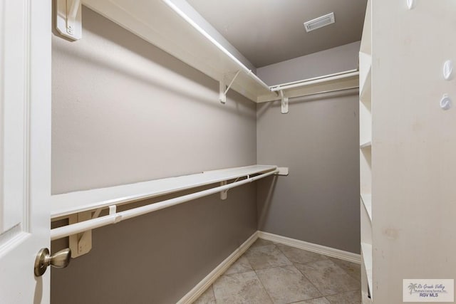 spacious closet with light tile patterned flooring