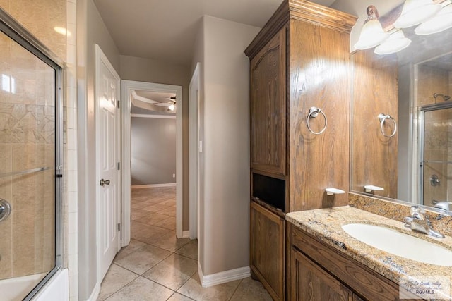 bathroom with vanity, tile patterned floors, and bath / shower combo with glass door