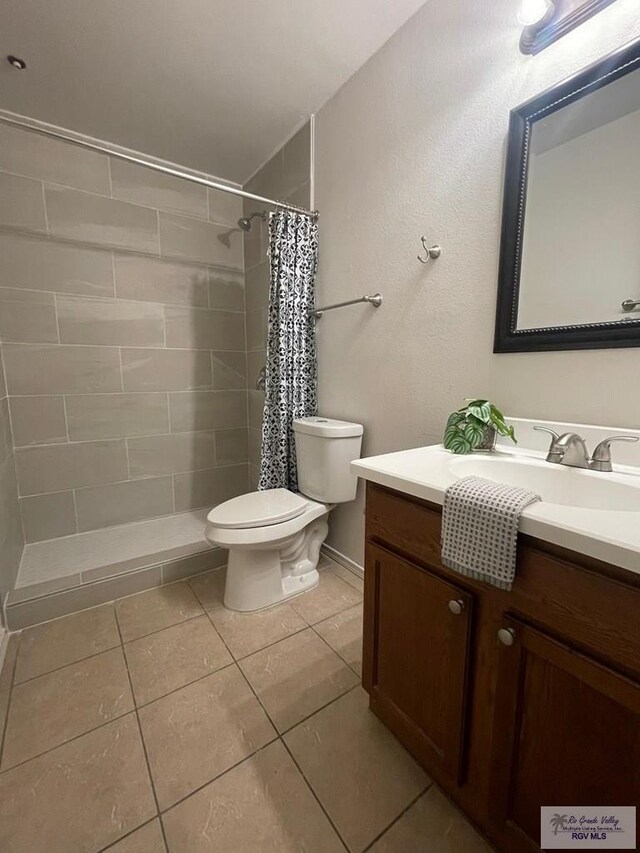 bathroom with tile patterned flooring, vanity, a shower with shower curtain, and toilet