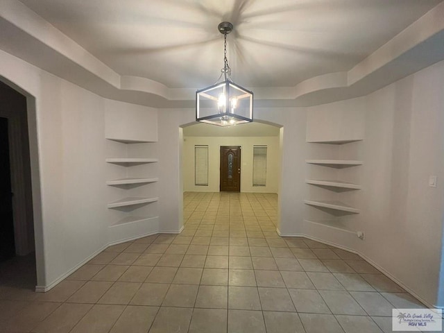 interior space with an inviting chandelier and light tile patterned flooring