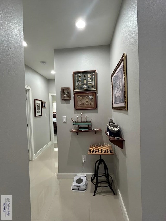 hallway with tile patterned flooring, baseboards, and recessed lighting