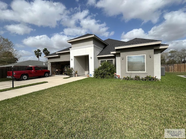 view of front of house featuring driveway, an attached garage, fence, a front lawn, and stucco siding