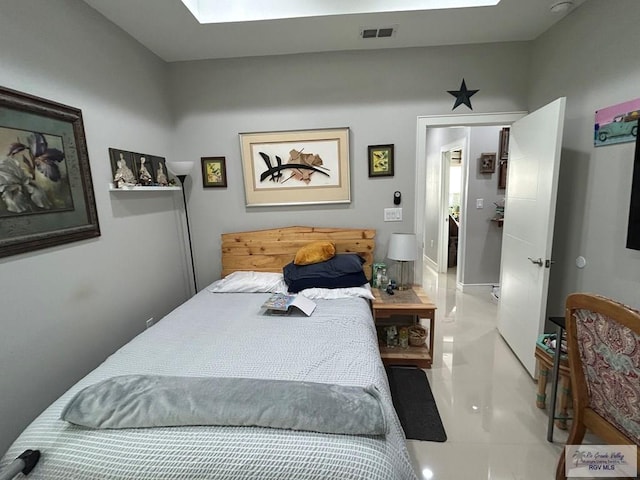 bedroom featuring a skylight and visible vents