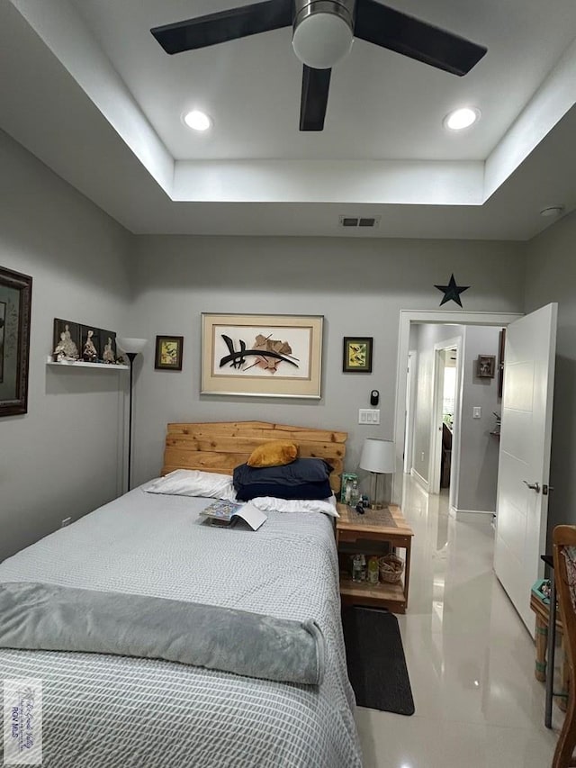 bedroom with a ceiling fan, recessed lighting, visible vents, and a tray ceiling