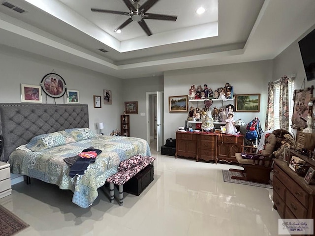 tiled bedroom featuring a tray ceiling, visible vents, ceiling fan, and recessed lighting