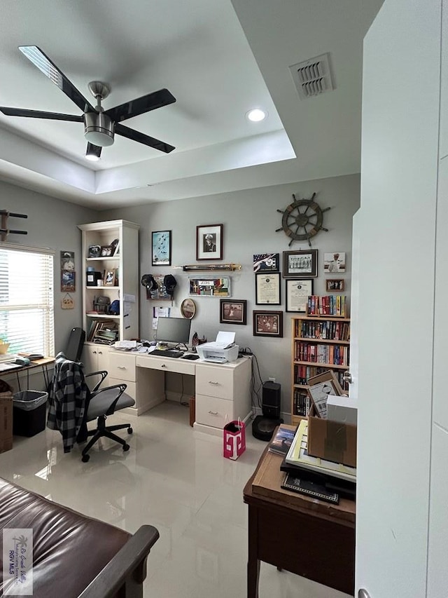 office featuring ceiling fan, visible vents, a raised ceiling, and recessed lighting