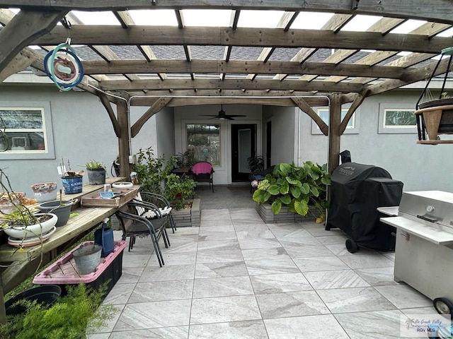 view of patio / terrace featuring area for grilling, a ceiling fan, and a pergola