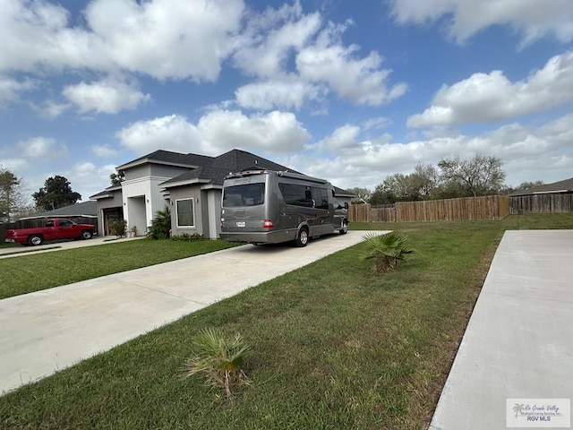 view of front of home featuring concrete driveway, an attached garage, fence, a front lawn, and stucco siding