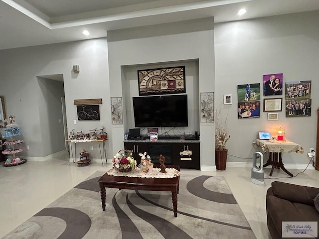 living room featuring baseboards and recessed lighting