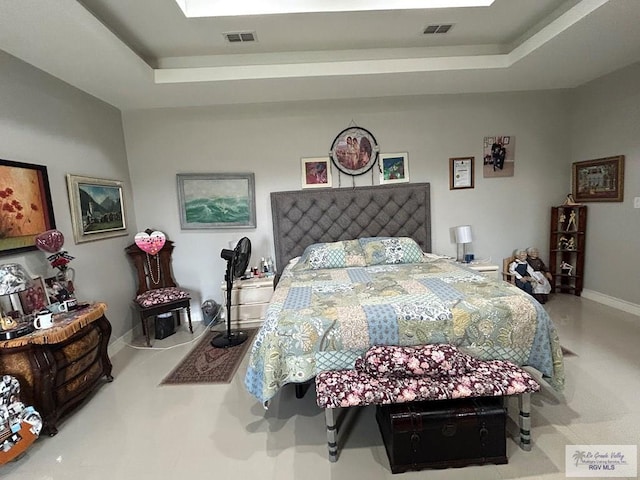 carpeted bedroom with a tray ceiling, visible vents, and baseboards