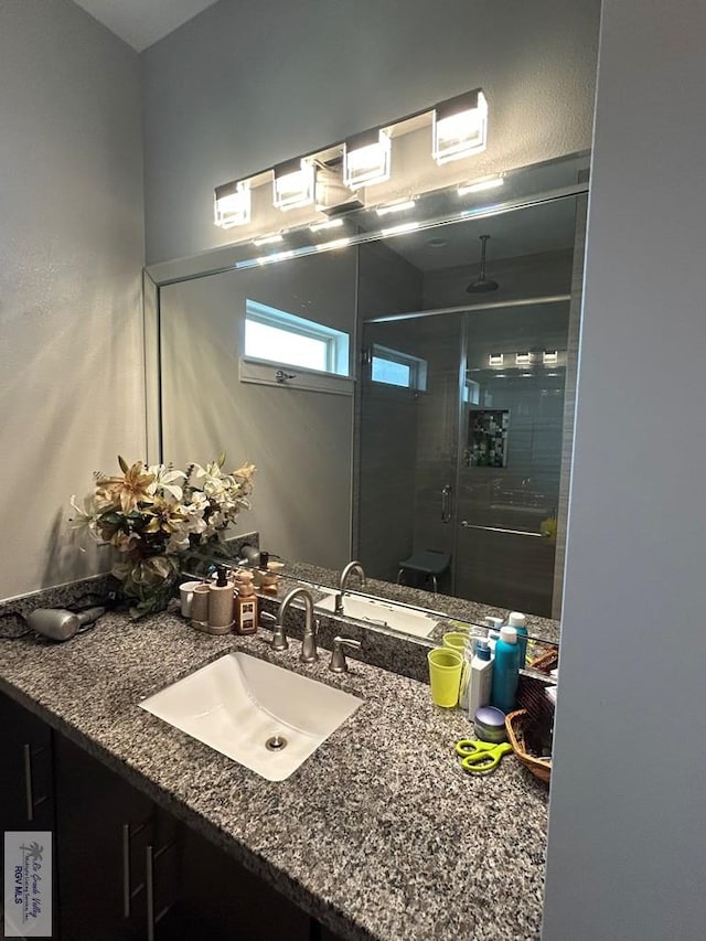 full bathroom featuring a shower stall and vanity