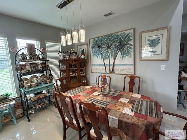 dining space with visible vents and light tile patterned flooring