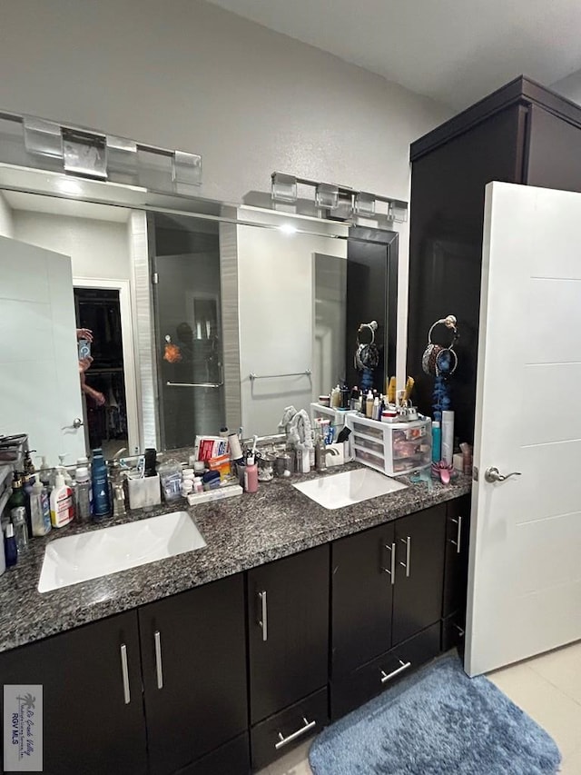 bathroom with a sink and double vanity