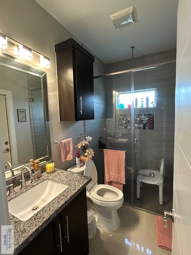 bathroom with tile patterned flooring, toilet, visible vents, vanity, and a stall shower