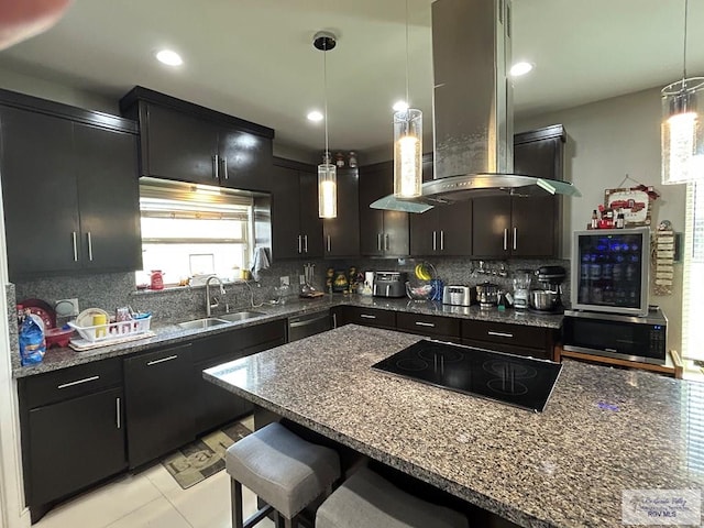 kitchen with appliances with stainless steel finishes, island range hood, backsplash, and a sink