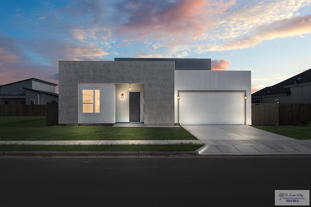 contemporary house with a garage and a lawn