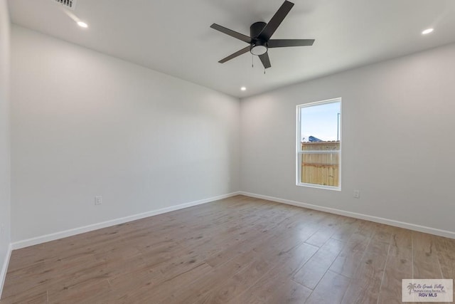 spare room with light hardwood / wood-style floors and ceiling fan