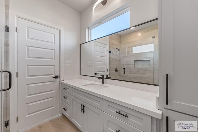 bathroom featuring vanity and a shower with shower door