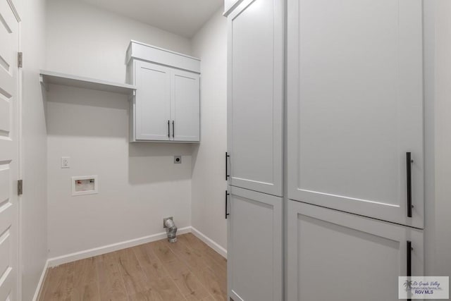 clothes washing area featuring cabinets, hookup for a washing machine, light hardwood / wood-style flooring, and hookup for an electric dryer