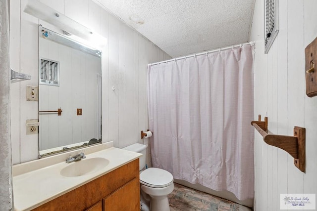 734 Billy Mitchell Blvd, Brownsville, TX 78521 - bathroom featuring toilet, vanity, a textured ceiling, wood walls, and wood finished floors