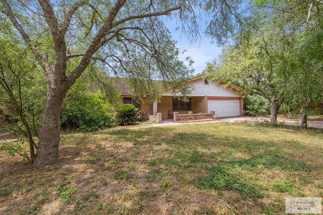 734 Billy Mitchell Blvd, Brownsville, TX 78521 - view of front of home with a garage, a front lawn, driveway, and a porch