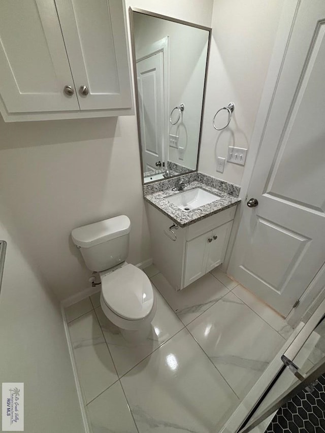 bathroom with tile patterned floors, vanity, and toilet