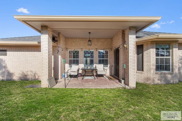 rear view of property featuring a yard and a patio