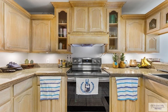 kitchen with stainless steel range with electric stovetop, premium range hood, and light brown cabinetry