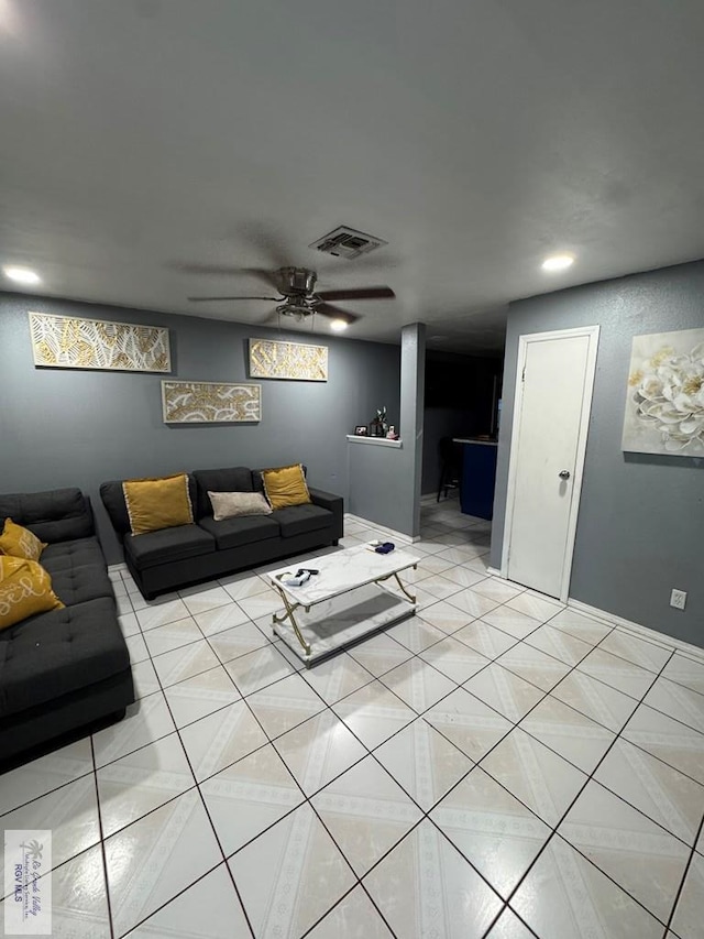 living room featuring light tile patterned floors and ceiling fan