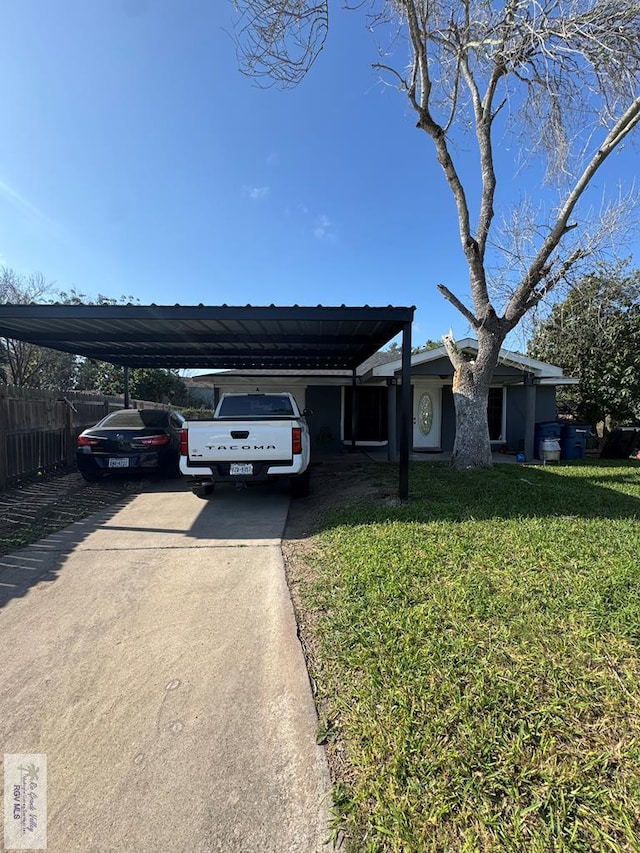 view of front of house with a carport and a front lawn